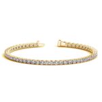 D41325988 1 Classic four prong 5 carat total weight diamond tennis bracelet showcasing perfectly matched brilliant round cut lab grown diamonds set in 14k yellow gold.